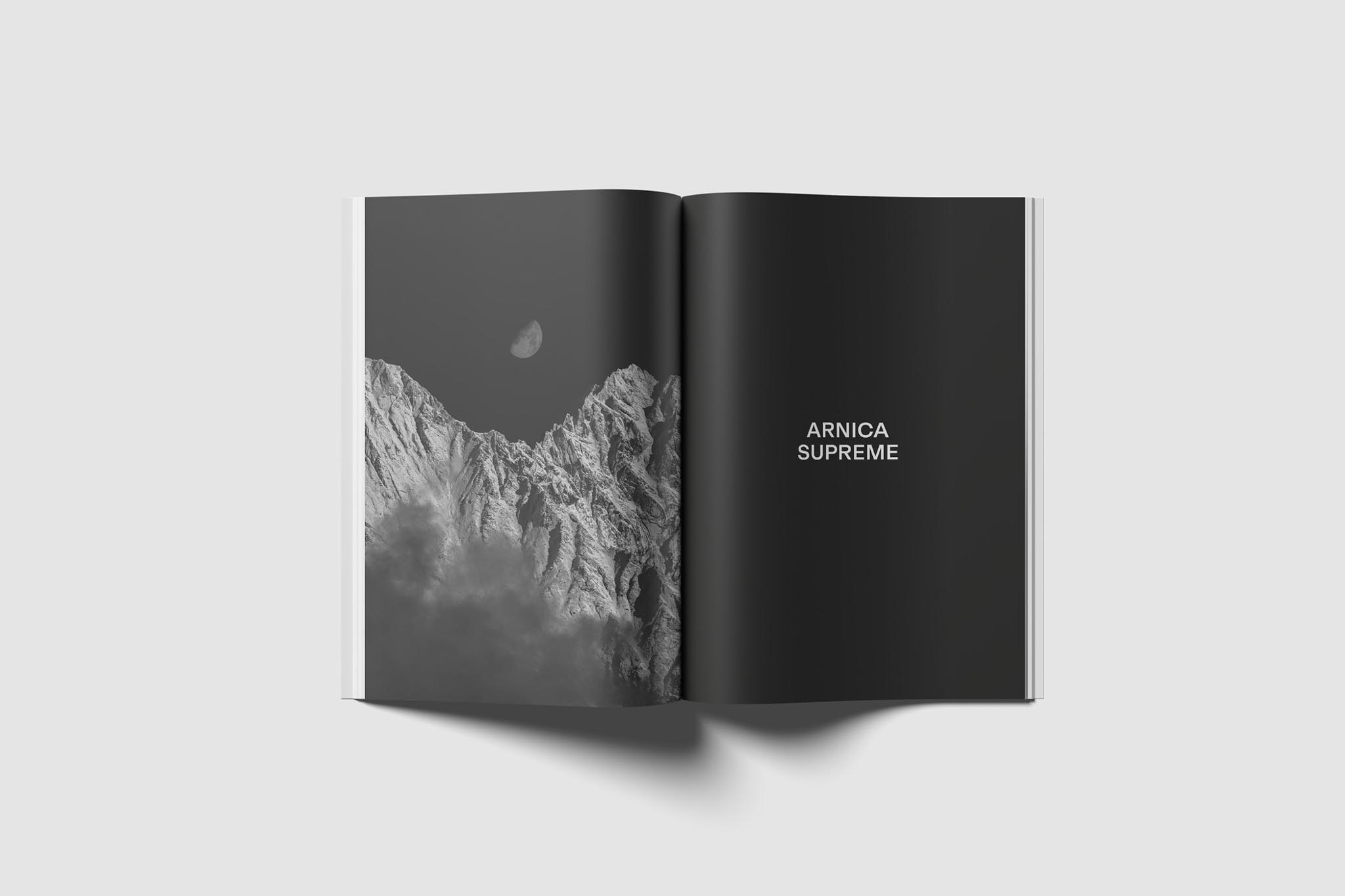 Offenes Buch mit Berg- und Mondmotiv, Text 'Arnica Supreme